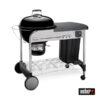 Schwarzer Weber Performer Premium GBS Holzkohlegrill mit silberfarbenem Gestell, einem Seitentisch und einem geschlossenen Deckel.